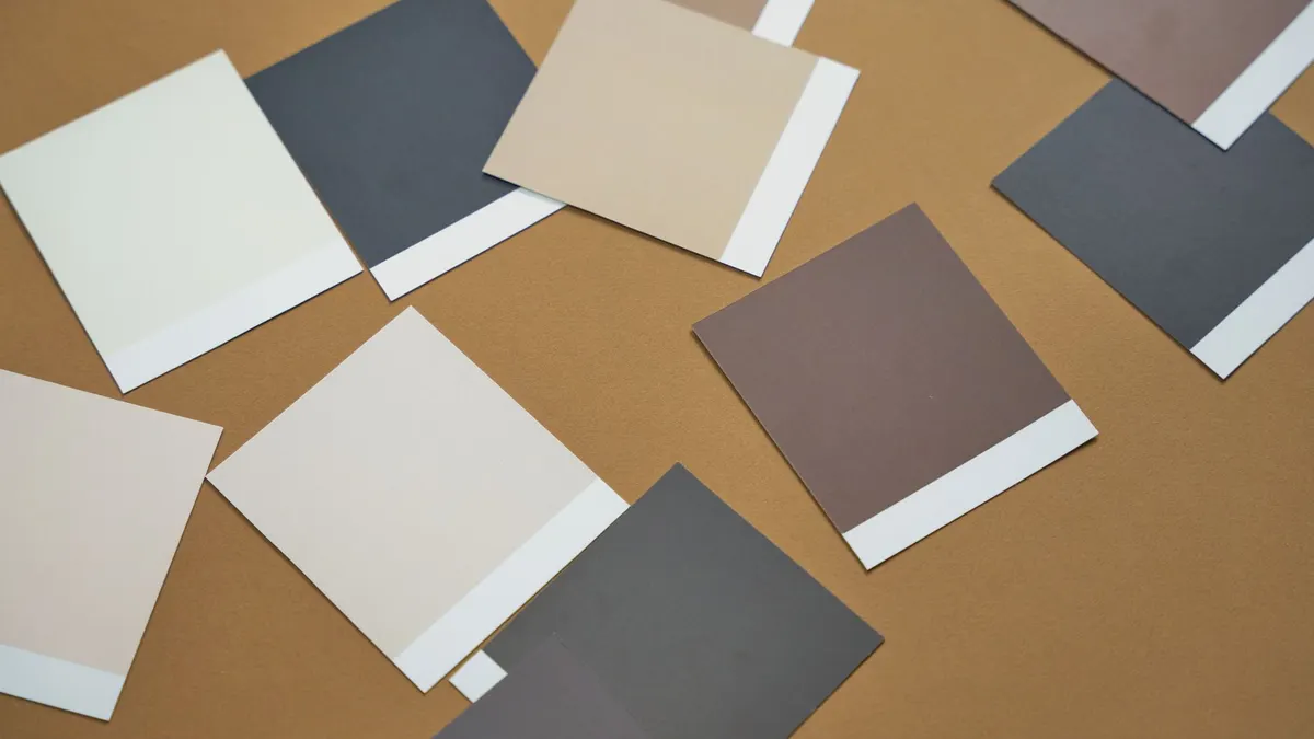 Paint color swatches compared against a wall