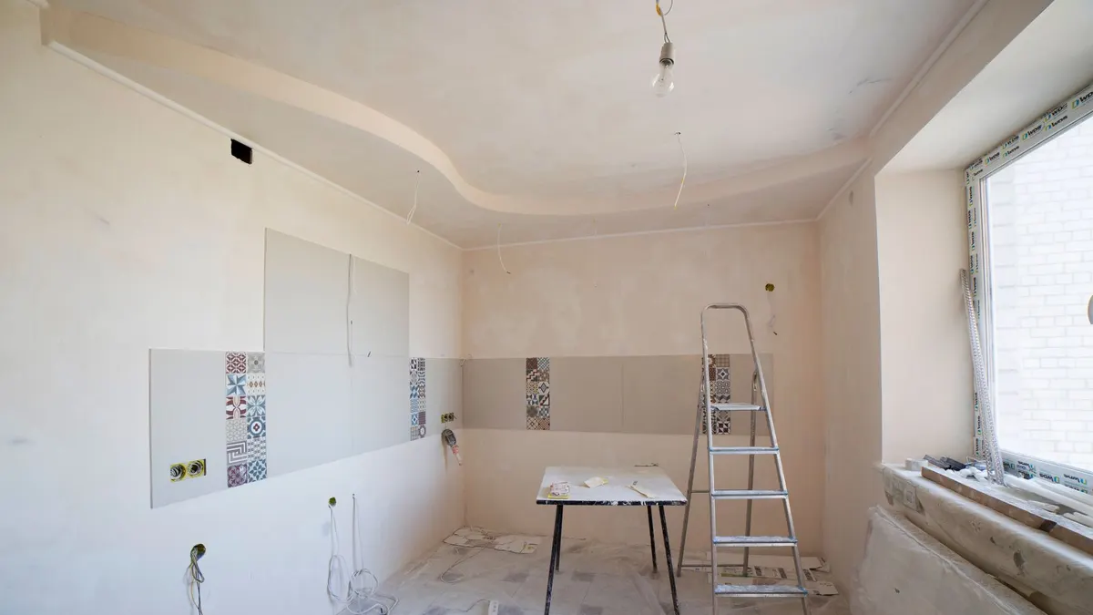 Empty room mid-renovation with bare walls ready for painting