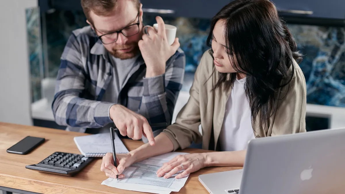 Homeowners reviewing a written project estimate together