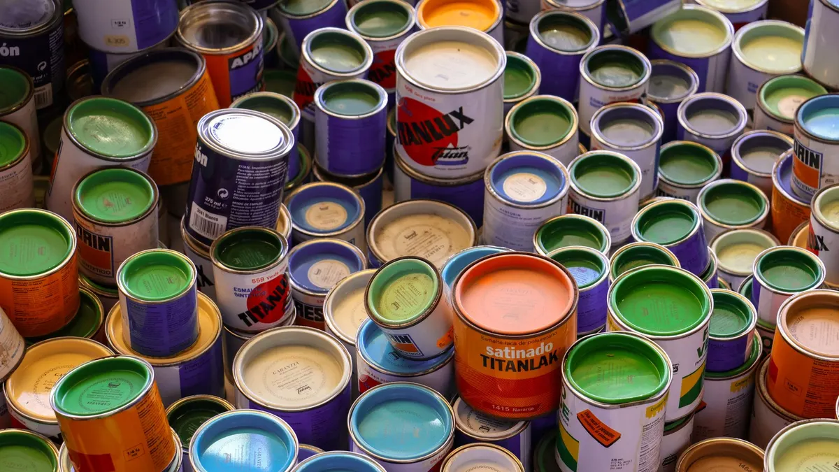 Rows of paint cans on a hardware store shelf