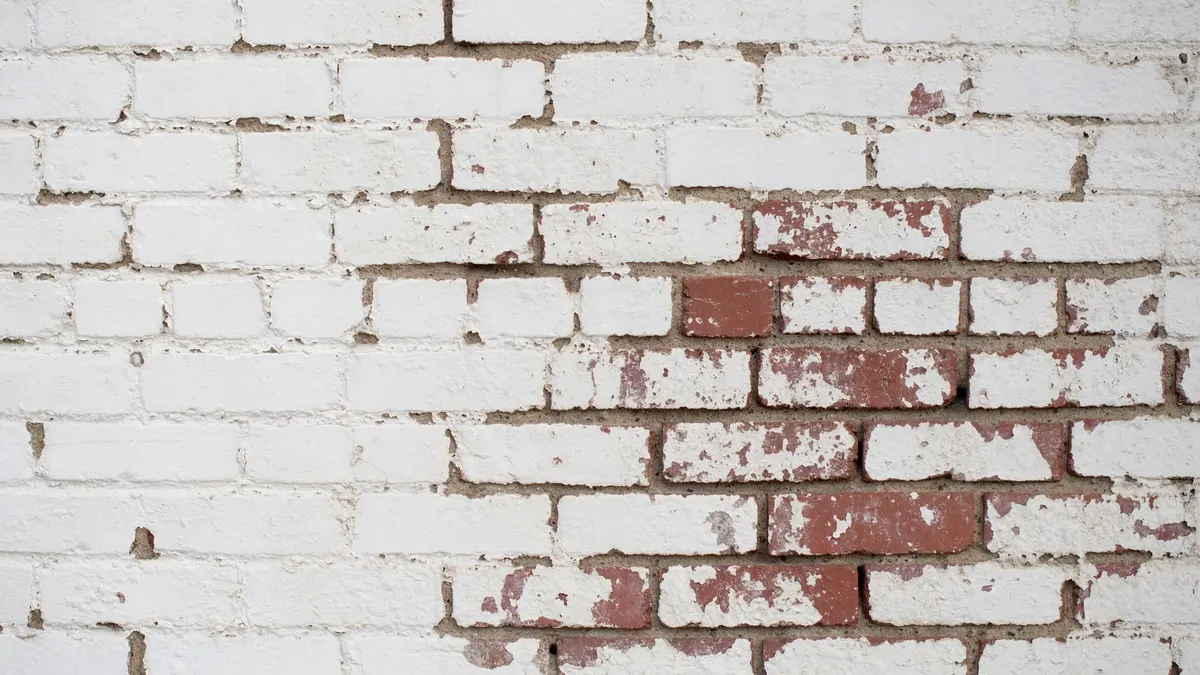 Limewashed brick wall exterior with soft, textured finish