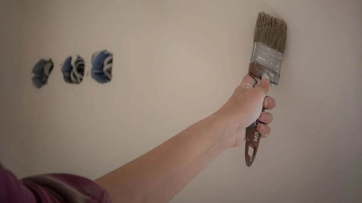 Wall scuff mark being assessed for a paint touch up
