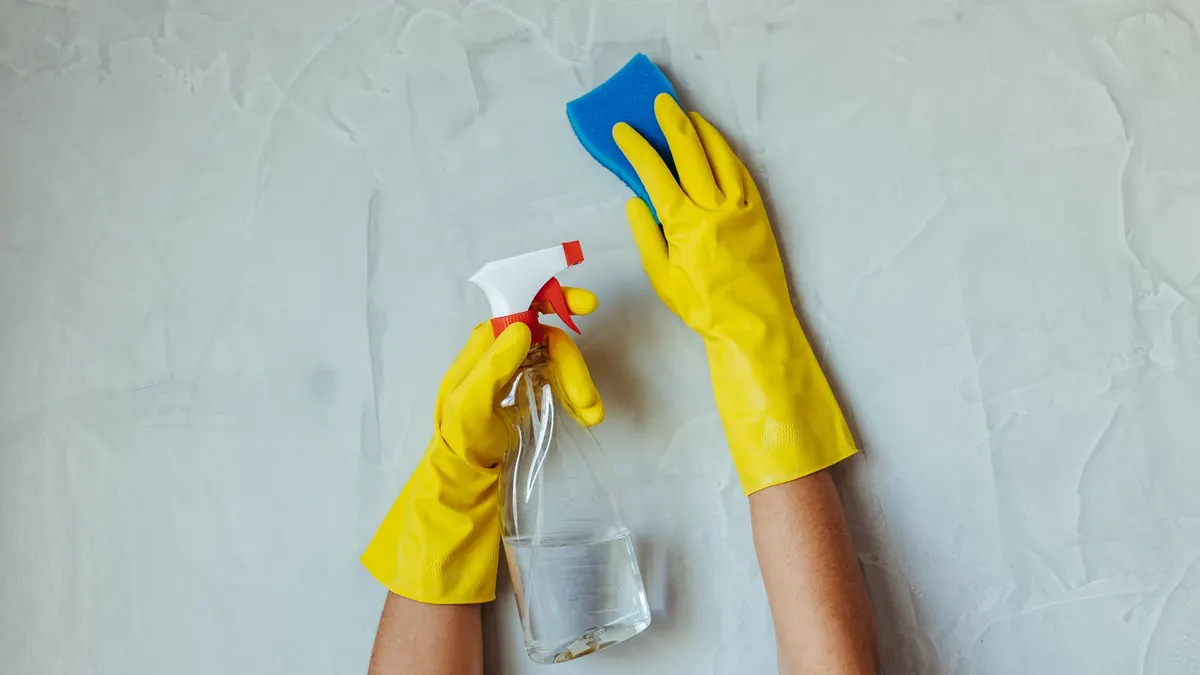 Cleaning a wall with a sponge before applying paint