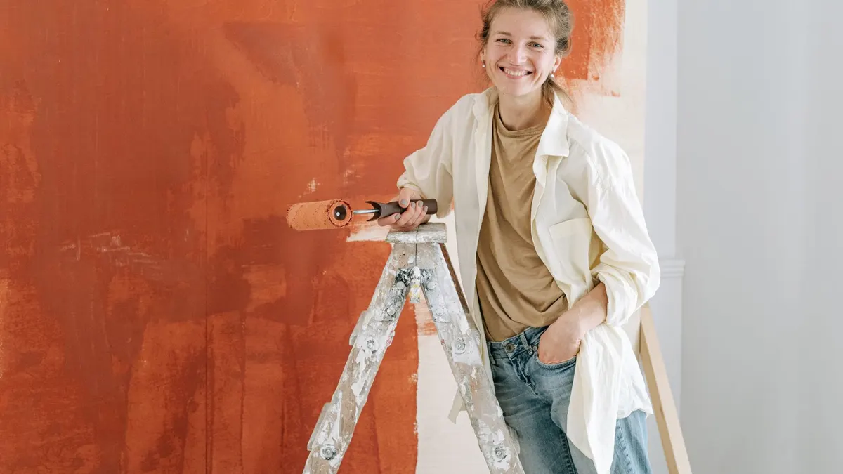Painter rolling a fresh coat onto a bedroom wall