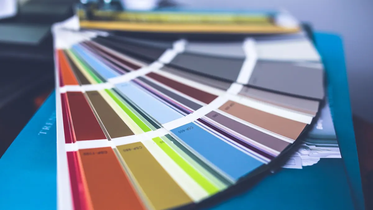 Paint color swatch held up against a wall in natural light